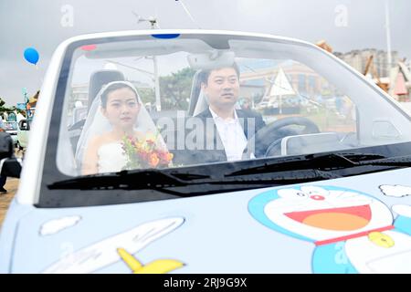 Couples participate in a collective wedding at the Gujing Group Jiushen ...