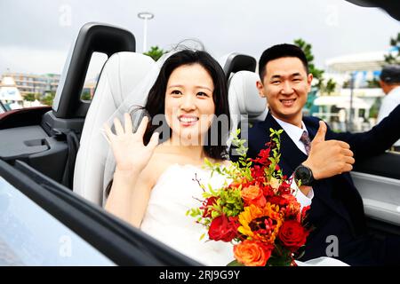 Couples participate in a collective wedding at the Gujing Group Jiushen ...