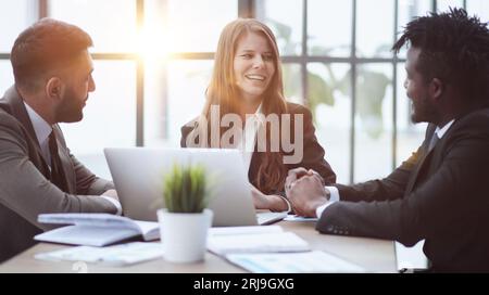 Team of interns and teacher studying marketing, working on startup project together. Stock Photo