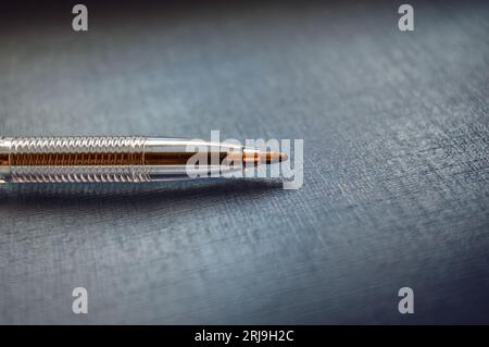 Ball pen laying on the gray surface, with cope space Stock Photo