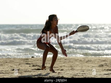 Playing Matkot ( paddle ball ) on the beach in Tel-Aviv. Stock Photo