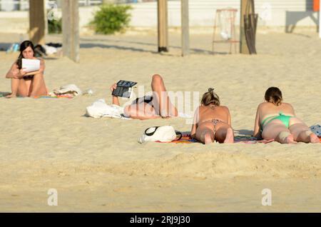 Women sunbathing on the beach in Tel-Aviv, Israel. Stock Photo