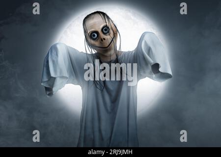 Scary Momo standing behind the wall in the dark background. Scary face for  Halloween. Halloween concept Stock Photo - Alamy