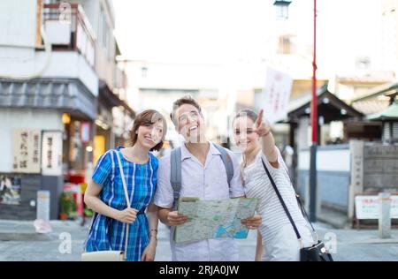 Male and female foreign tourists checking where they are going on a map Stock Photo