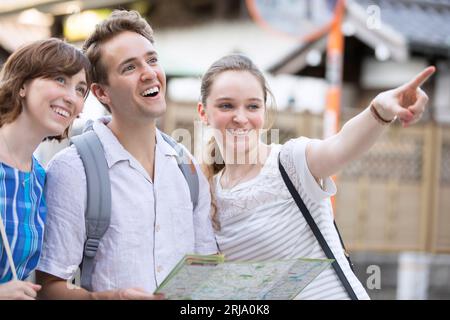 Male and female foreign tourists checking where they are going on a map Stock Photo