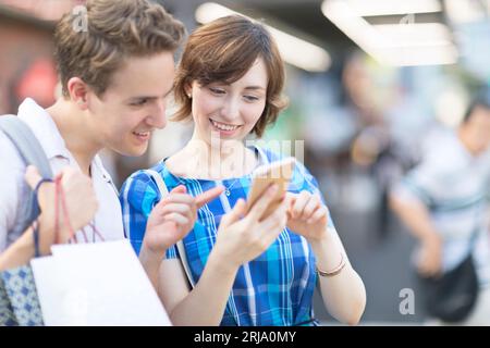 A foreign tourist checking where she is going on her smartphone Stock Photo