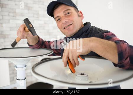 handyman repairing chair in apartment Stock Photo