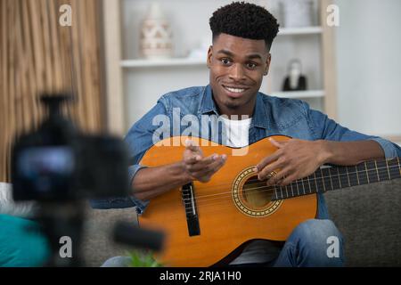young guitar player recording video for his blog Stock Photo