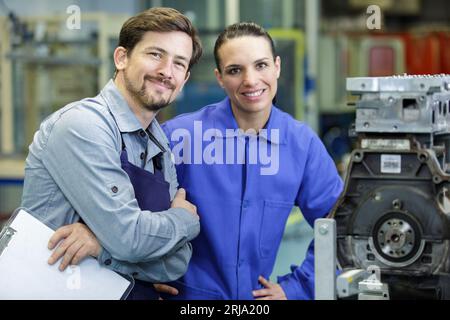 man and woman next to machine Stock Photo
