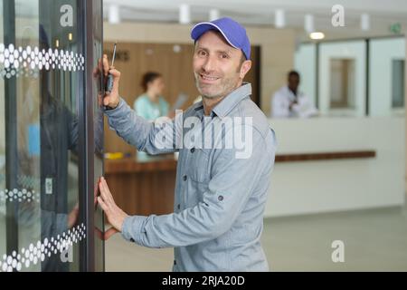 worker are repairing automatic door in hospital Stock Photo