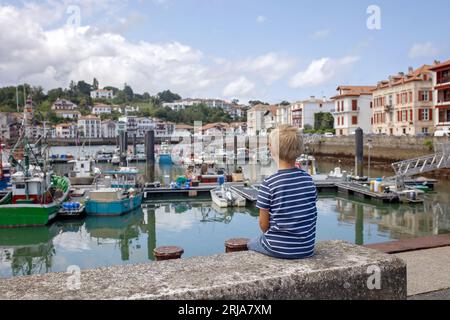 Family, visiting small town in France, Saint Jean de Luz, during summer vacation, traveling with children in Europe Stock Photo