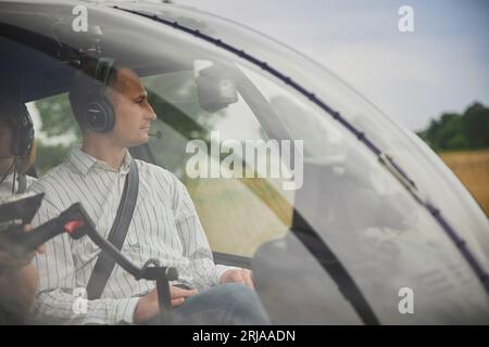 Taastrup, Denmark, August 11,2023: Man in the helicopter cockpit  Stock Photo