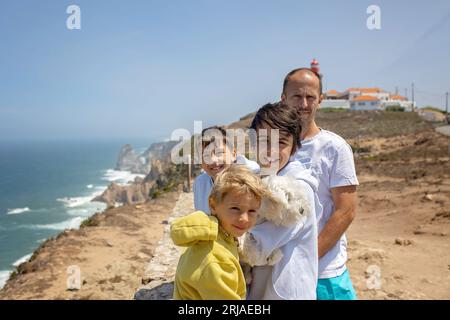 Family with children, siblings, visiting the most west point of Europe, Cabo Da Roca, during family vacation summertime in Portugal Stock Photo