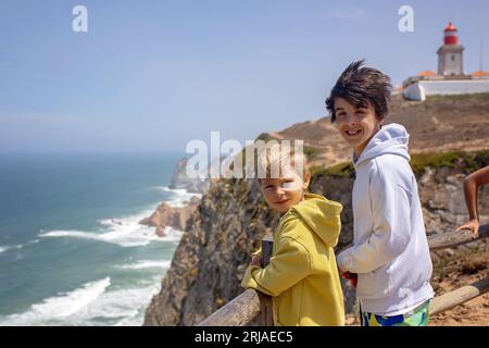 Family with children, siblings, visiting the most west point of Europe, Cabo Da Roca, during family vacation summertime in Portugal Stock Photo