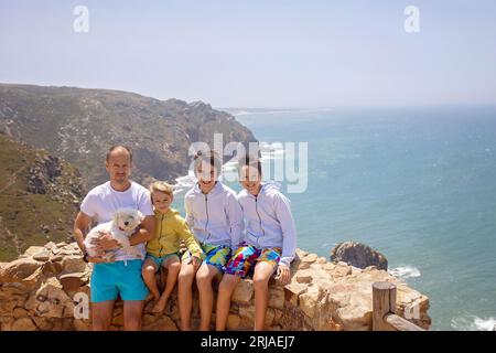 Family with children, siblings, visiting the most west point of Europe, Cabo Da Roca, during family vacation summertime in Portugal Stock Photo