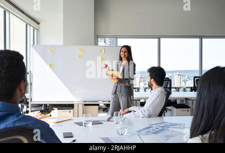 Happy Indian business woman professional giving presentation in office. Stock Photo
