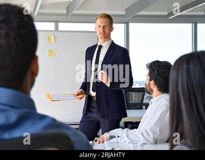 Business man presenter team leader giving presentation in office. Stock Photo