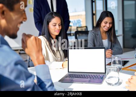 Diverse professional business team at office meeting with laptop mock up screen. Stock Photo