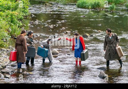 The cast of HOME from the Temper Theatre company during a photocall in the Water of Leith, Edinburgh. The show highlights the climate crisis and how flooding is affecting the Fens in East Anglia and is being performed at the Pleasance Courtyard during the Edinburgh Fringe Festival. Picture date: Tuesday August 22, 2023. Stock Photo