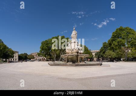 Nîmes, Gard, France - 08 17 2023 : Cityscape view of landmark Pradier fountain on the Charles de Gaulle esplanade with historic arena in background Stock Photo