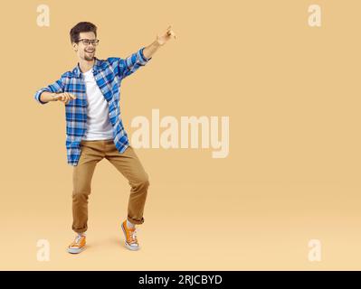 Full length body size photo of happy dancing young man Stock Photo