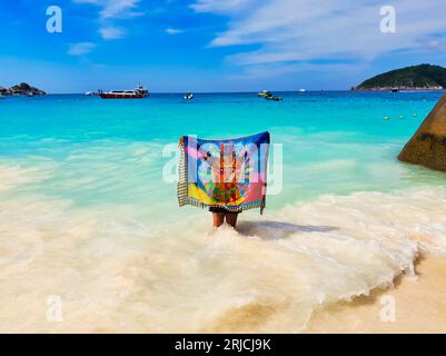 December 31st, 2018, Phuket, Thailand -A tourist poses for a photo at the scenic Similan Islands beach with blue-green waters and silver sands Stock Photo