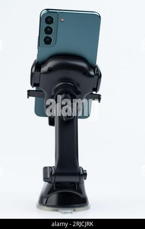 Smartphone in car mount holder rear view isolated on studio background Stock Photo