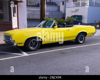 A vintage Oldsmobile 442 convertible, likely from the 1970s, parked in a side street in Westchester, a suburb of New York City. Stock Photo