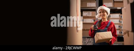 Inventory manager scans cardboard box with barcode scanner, worker holds package. Cardboard boxes with products ready for shipment. Stock Photo