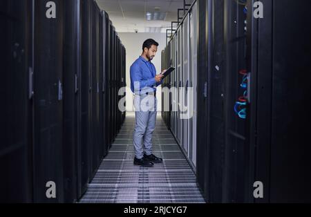 Tablet, man and engineer in server room, research and programming. Information technology, reading and technician in data center, network on Stock Photo