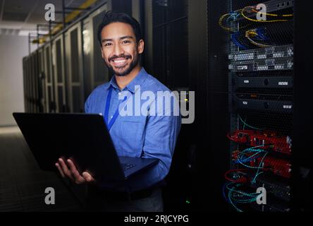 Man, data center and computer in programming portrait, server room coding and programming or cybersecurity. Business person on laptop and engineering Stock Photo