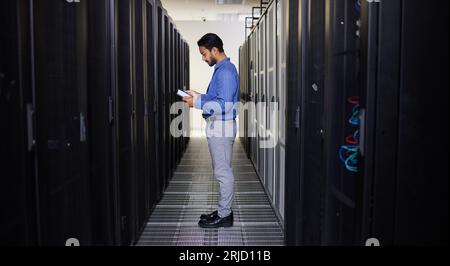 Tablet, man and technician in data center on research for programming at night. Information technology, inspection and engineer in server room reading Stock Photo