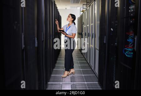 Tablet, woman and engineer in data center for inspection of programming hardware. Information technology, check and technician in server room Stock Photo