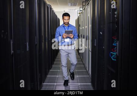 Tablet, man and engineer in data center on research for programming on app. Information technology, inspection and technician in server room reading Stock Photo
