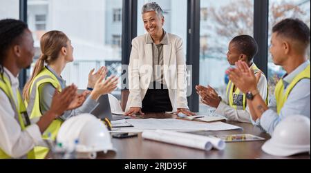 Applause, talking and construction workers in a meeting with a manager for architecture success. Happy, team and architects clapping for a Stock Photo