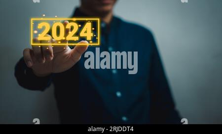 Hand man touching button 2024 new year. Stock Photo