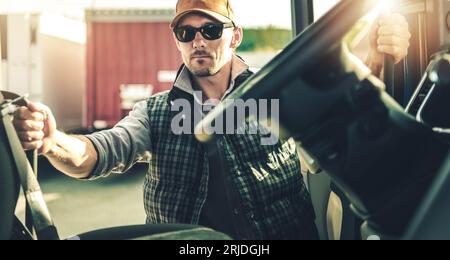 Semi Truck Driver and His Modern Truck Tractor. Getting Ready For the Next Destination. Stock Photo