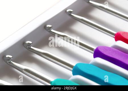 Close-up on crochet hooks set in different sizes with multicoloured handles Stock Photo