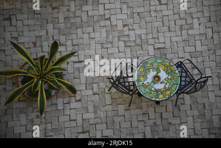 Lava stone table top with Sicilian Caltagirone lemons and cactus motifs in Sciacca Sicily, Italy. Stock Photo