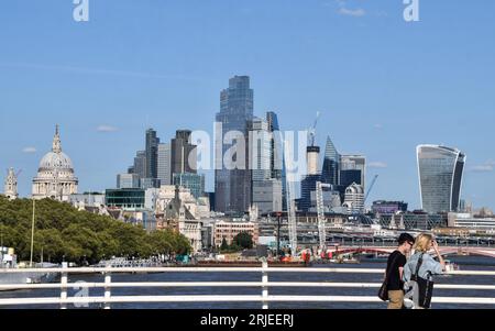 London, England, UK. 22nd Aug, 2023. People walk along Waterloo Bridge past the City of London skyline on a warm, sunny day. (Credit Image: © Vuk Valcic/ZUMA Press Wire) EDITORIAL USAGE ONLY! Not for Commercial USAGE! Stock Photo
