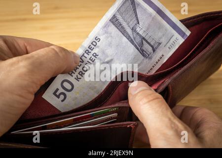 Denmark Money, 50 danish kroner banknote taken out of wallet, Financial and business concept, close up Stock Photo