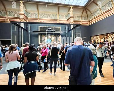 Amsterdam, Netherlands. August 6, 2023. Visitors admire one of the many paintings at the Rijksmuseum in Amsterdam. High quality photo Stock Photo