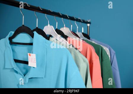 Clothes for sale hang on a hanger. T-shirts for men and blouses for women Stock Photo