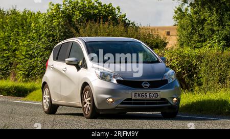 Woburn,Beds.UK - August 19th 2023: 2015 silver Nissan Note  car travelling on an English country road. Stock Photo
