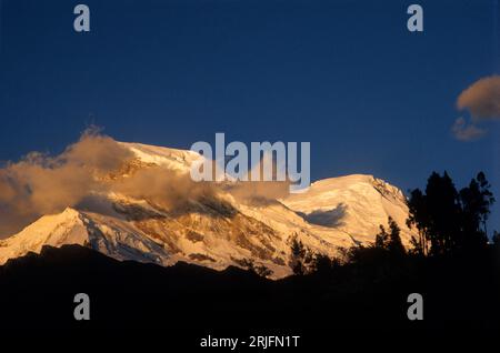 Peru, Andes Montain Range - Cordillera de los Andes, Cordillera Blanca. Sunset over Mount Huascarán (6768 m), highest mountain in Peru. Stock Photo