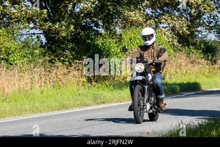 Woburn,Beds.UK - August 19th 2023:  2022 silver Royal Enfield HimalayanE5 motorcycle travelling on an English country road. Stock Photo
