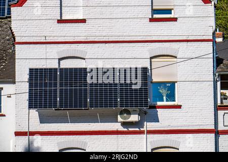 Solar installation on the exterior wall of a residential building, Stock Photo