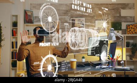 Freelancer at home wearing VR goggles using augmented reality to visualize final result after working on machinery construction using cad engineering software on computer, developing engine product Stock Photo
