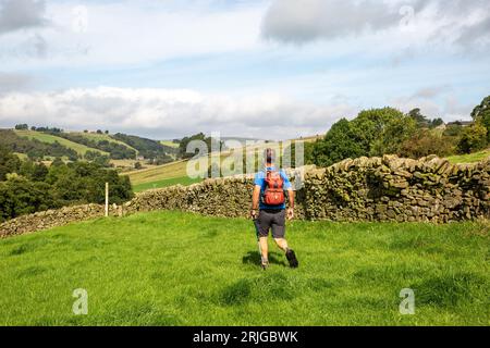 Man walking  in the countryside along the North Staffordshire Peak District footpath the Manifold Trail near Longnor Stock Photo