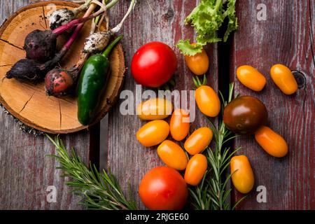 Vegetables yellow cherry tomatoes and red tomatoes on wooden table. Stock Photo